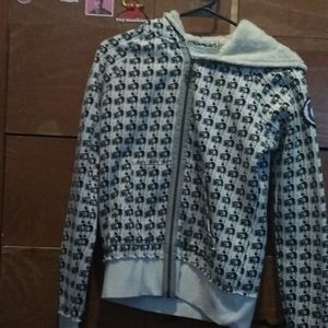 Girl holding stereo white zip up hoodie